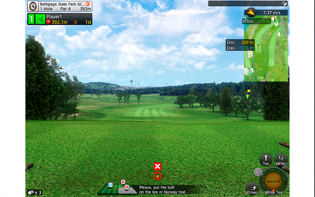 A golf simulator setup featuring a powerful projector and detailed golf course visuals.