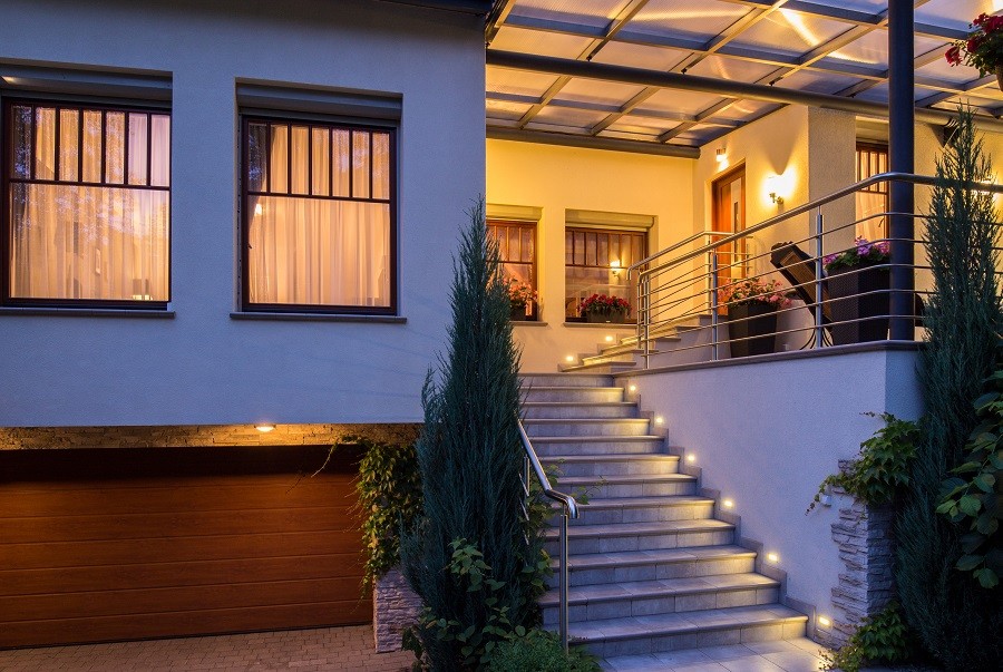 A modern home illuminated with sophisticated landscape lighting. 