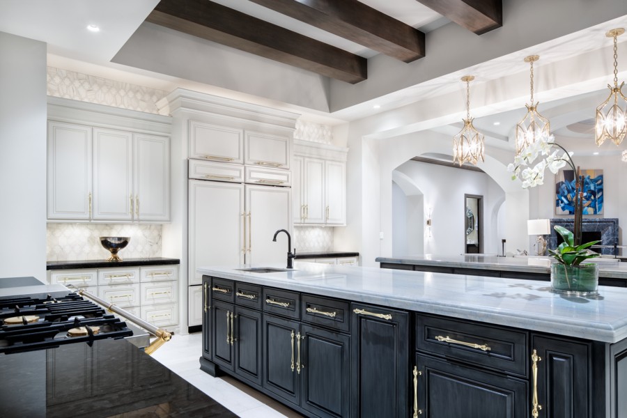 a kitchen with black cabinets and white countertops