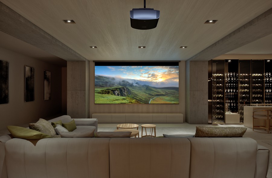 A casual home theater with a Sony projector, a large movie screen, and a sectional.