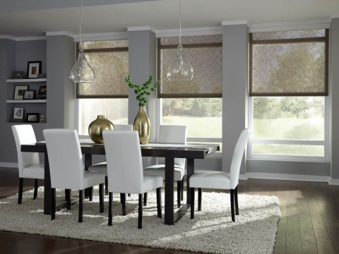  A dining area with half-drawn shades and sunlight filtering into the room.