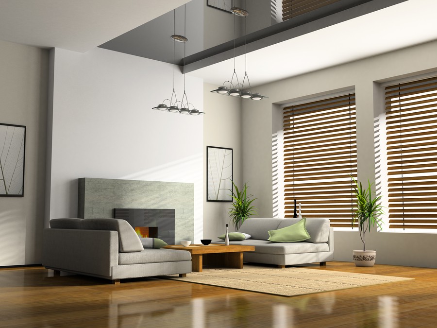 Image is of modern wood blinds and shades in a living room.