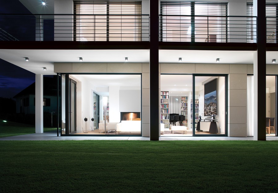  A well-lit home with floor-to-ceiling blinds on the second floor.