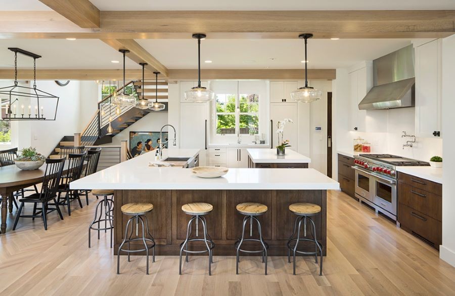 A kitchen and dining area illuminated with varying types of lights. 