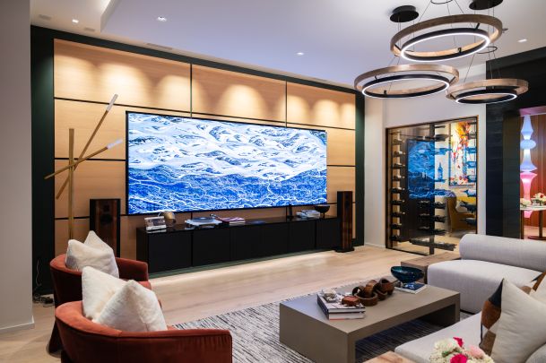 Elegant living room with a large Just Video Walls screen displaying a dynamic blue and white river pattern.